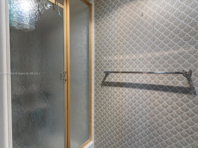 bathroom with a shower with shower door