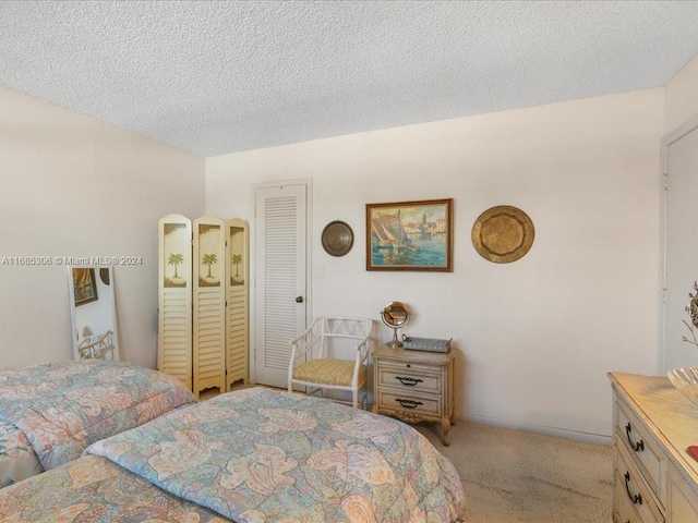 carpeted bedroom featuring a textured ceiling