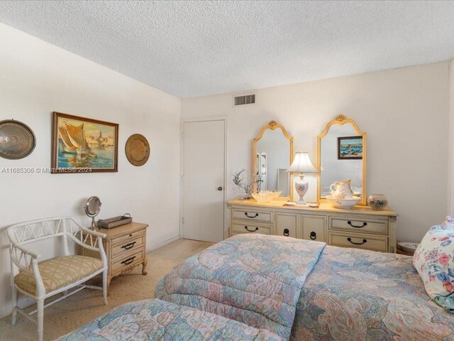 carpeted bedroom featuring a textured ceiling