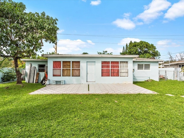 rear view of house with a yard and a patio