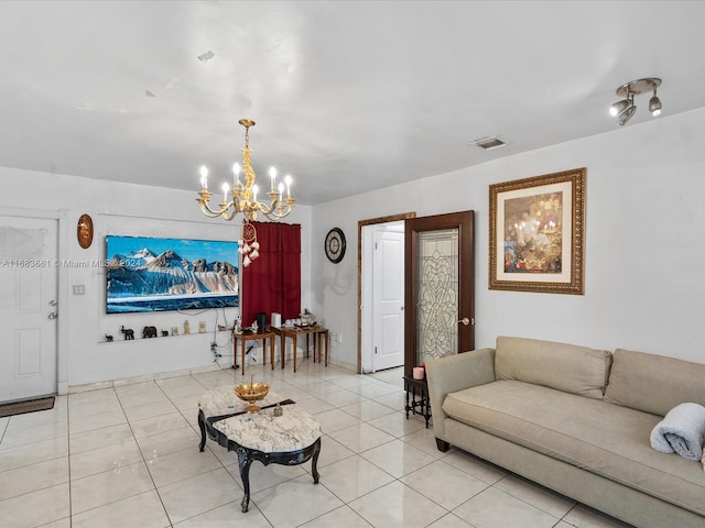 living room with a chandelier and light tile patterned floors