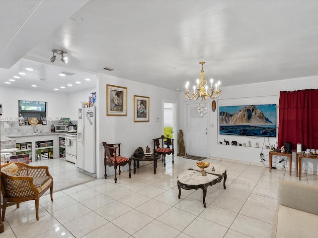 living room with an inviting chandelier and light tile patterned flooring