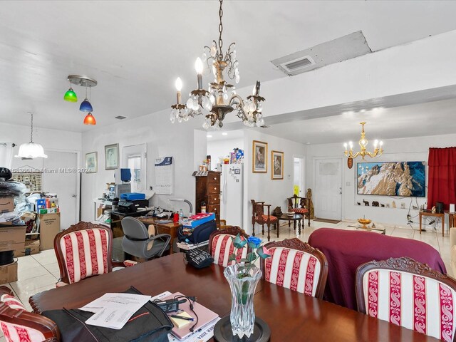 dining area with an inviting chandelier and light tile patterned floors