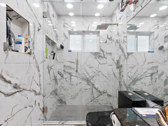 bathroom featuring a shower with shower door and tile walls