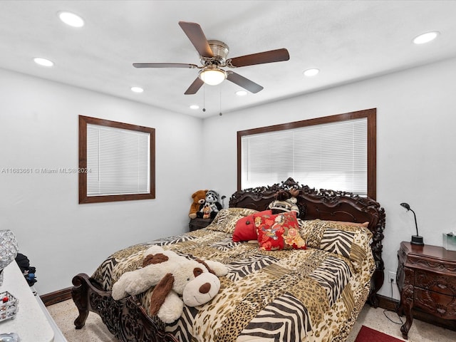 bedroom featuring light colored carpet and ceiling fan