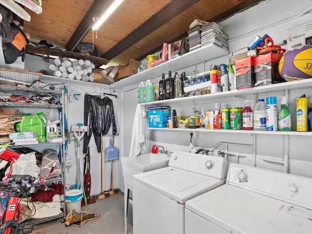 clothes washing area with washing machine and dryer