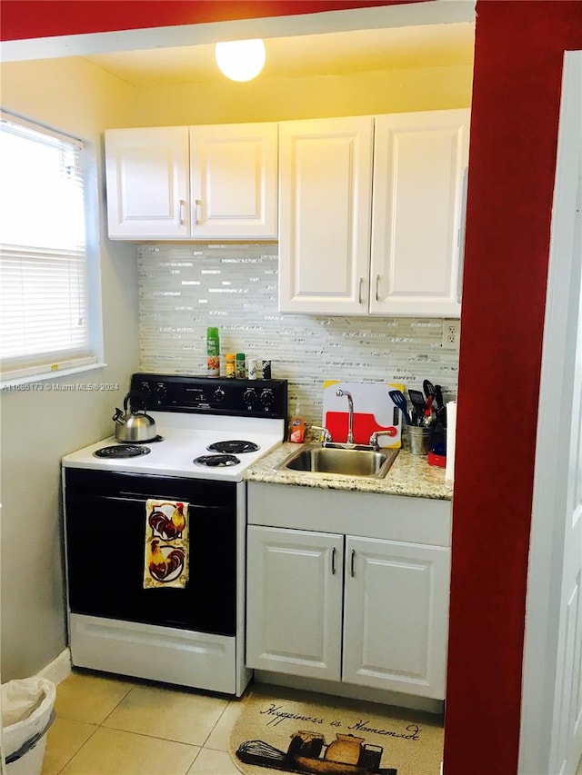 kitchen with white cabinetry, white electric range, sink, and light tile patterned floors