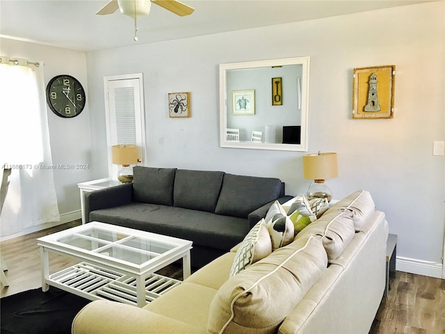 living room featuring ceiling fan and wood-type flooring