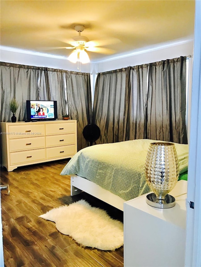 bedroom with ceiling fan and hardwood / wood-style flooring