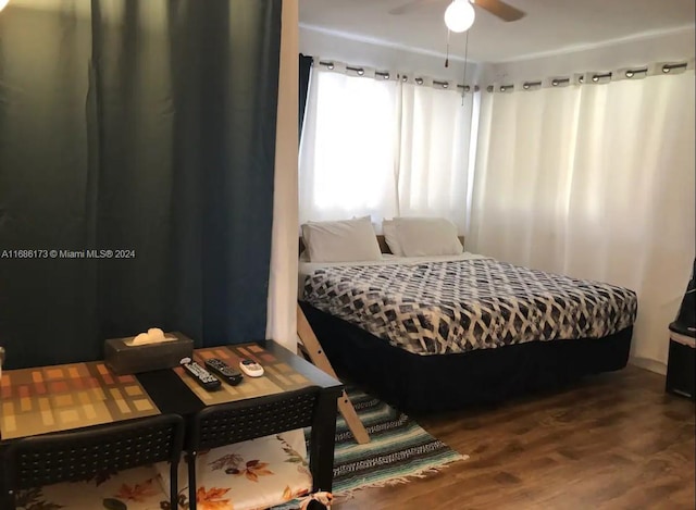 bedroom with wood-type flooring and ceiling fan