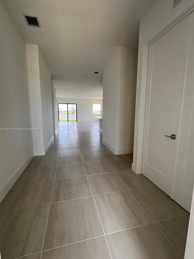 hall with light tile patterned flooring