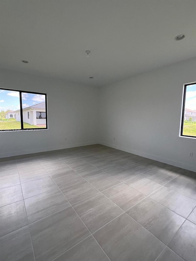 spare room with light tile patterned floors