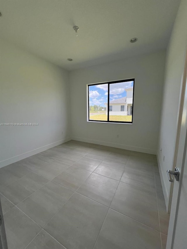 empty room with light tile patterned floors