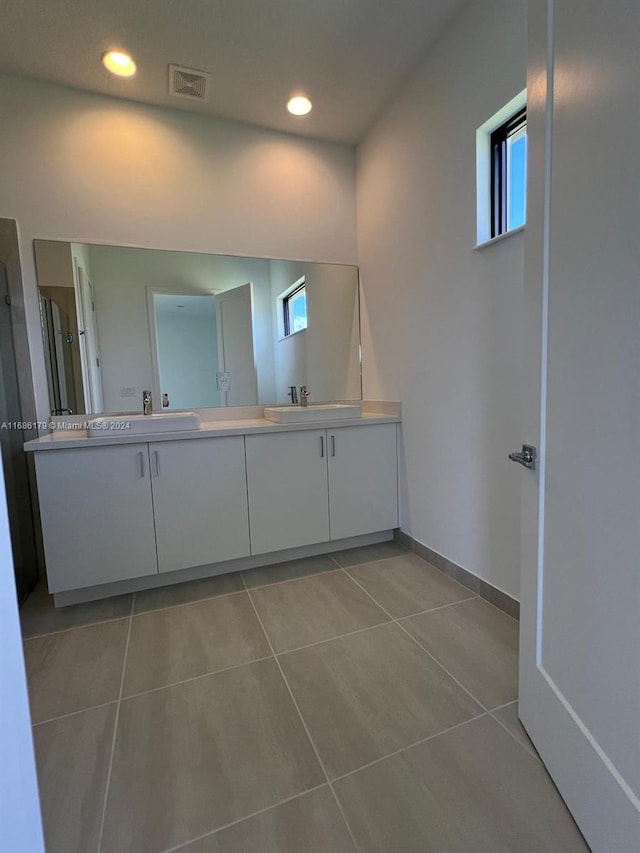 bathroom with tile patterned floors and vanity