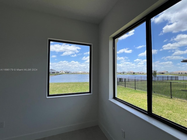 unfurnished room with a water view