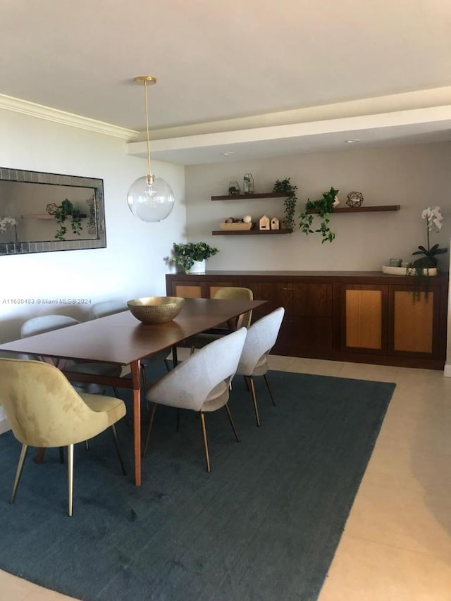 dining area featuring crown molding and light tile patterned floors