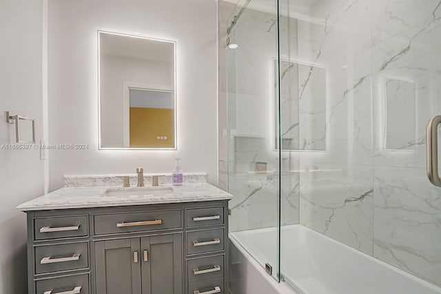 bathroom featuring vanity and shower / bath combination with glass door