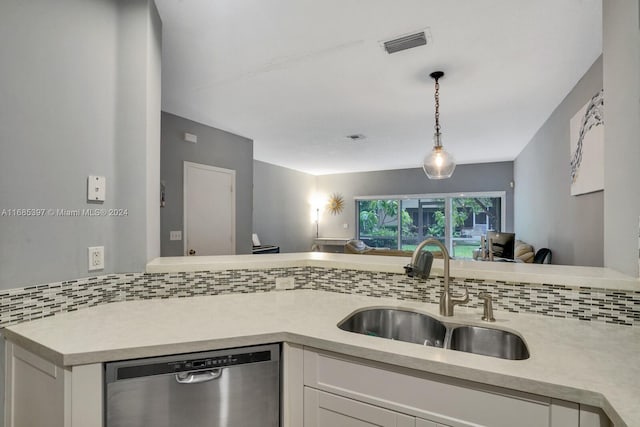 kitchen featuring sink, white cabinetry, dishwasher, and tasteful backsplash