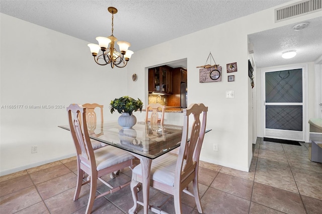 410 SE 2nd St Unit 220, Hallandale Beach, FL 33009 - dining area with baseboards, a chandelier, a textured ceiling, and visible vents