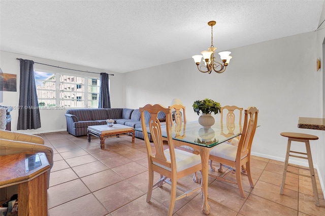 410 SE 2nd St Unit 220, Hallandale Beach, FL 33009 - dining space with an inviting chandelier, baseboards, a textured ceiling, and light tile patterned floors