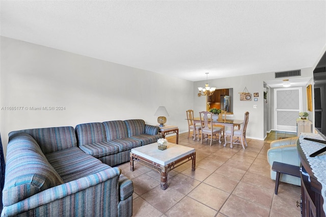 410 SE 2nd St Unit 220, Hallandale Beach, FL 33009 - living area featuring baseboards, a notable chandelier, visible vents, and light tile patterned floors