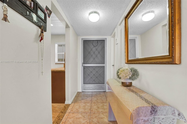 410 SE 2nd St Unit 220, Hallandale Beach, FL 33009 - doorway to outside featuring a textured ceiling and baseboards