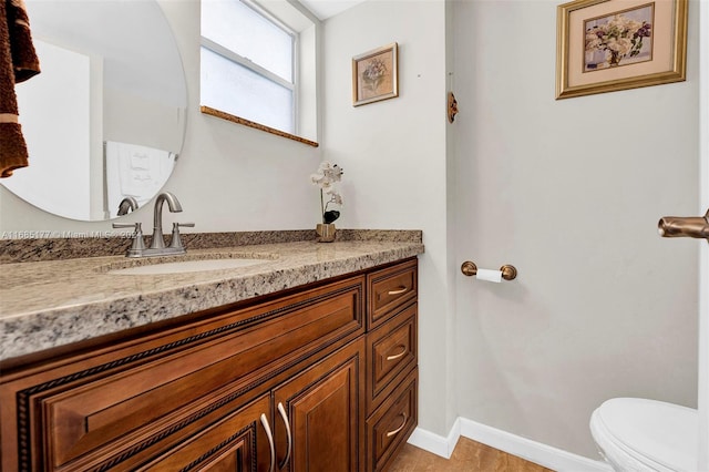 410 SE 2nd St Unit 220, Hallandale Beach, FL 33009 - half bathroom featuring vanity, baseboards, and toilet