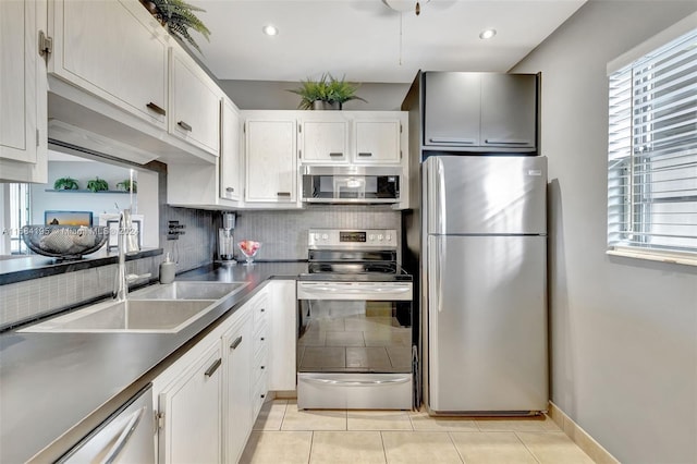 kitchen featuring white cabinetry, tasteful backsplash, appliances with stainless steel finishes, and sink