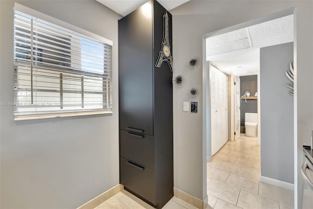 bathroom with toilet and tile patterned floors