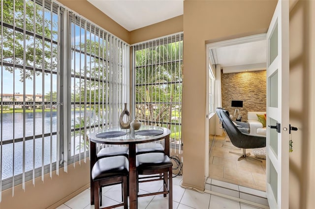 sunroom / solarium with a water view and plenty of natural light