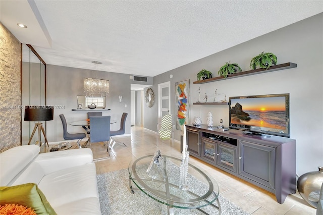 tiled living room with a textured ceiling and a chandelier