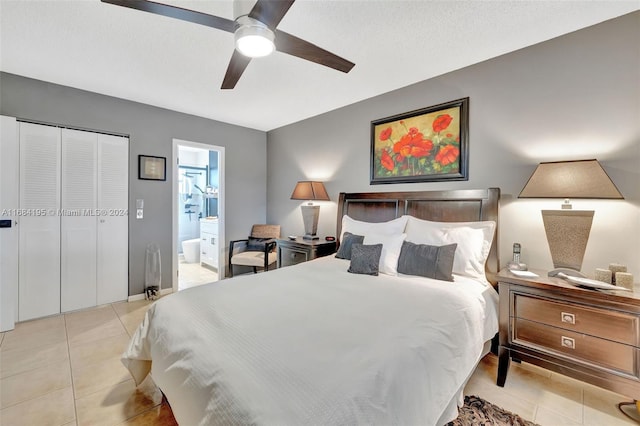 tiled bedroom featuring connected bathroom, a closet, and ceiling fan