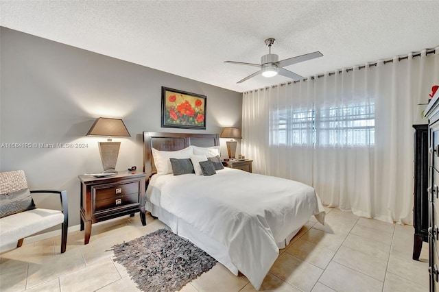 tiled bedroom featuring a textured ceiling and ceiling fan