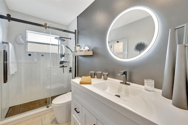 bathroom with vanity, tile patterned floors, toilet, and walk in shower