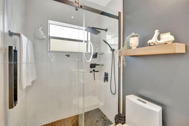 bathroom featuring toilet and walk in shower