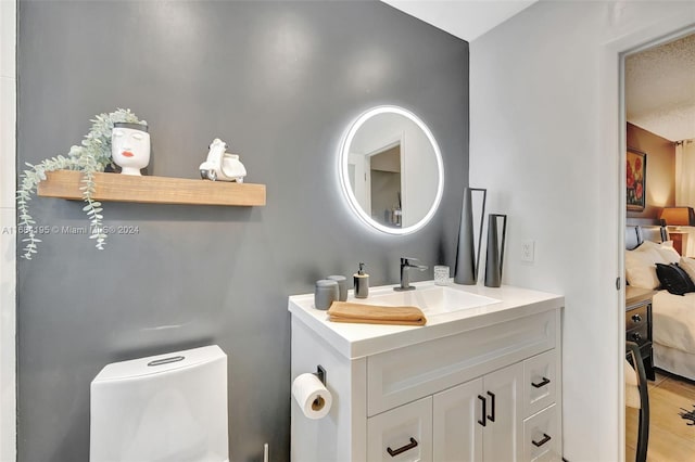 bathroom with vanity, toilet, tile patterned floors, and a textured ceiling