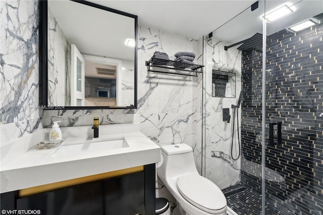 bathroom with tile walls, vanity, toilet, and walk in shower