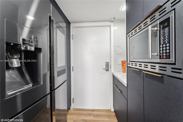 kitchen with light hardwood / wood-style floors and stainless steel appliances