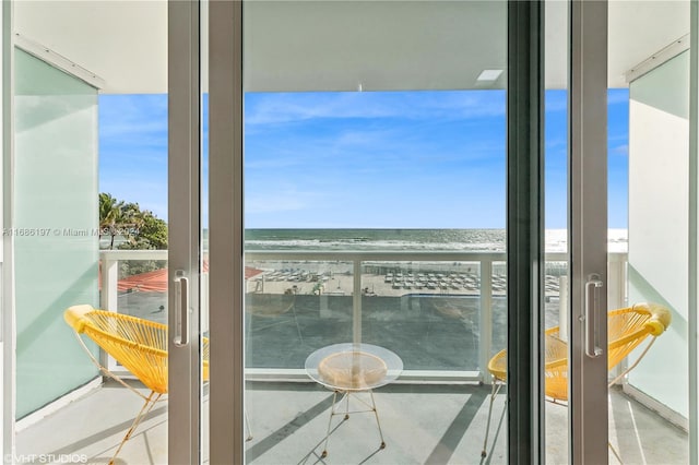 balcony with a water view and a beach view