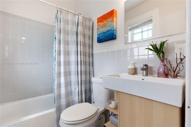 full bathroom featuring vanity, tile walls, shower / bath combo with shower curtain, and toilet