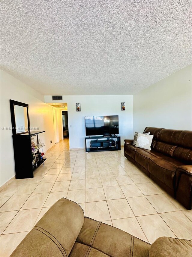 tiled living room with a textured ceiling