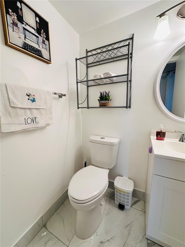 bathroom featuring toilet and vanity