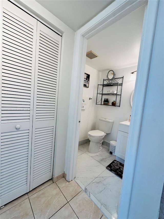 bathroom featuring toilet and vanity