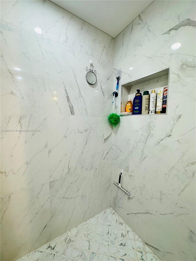 bathroom with tiled shower