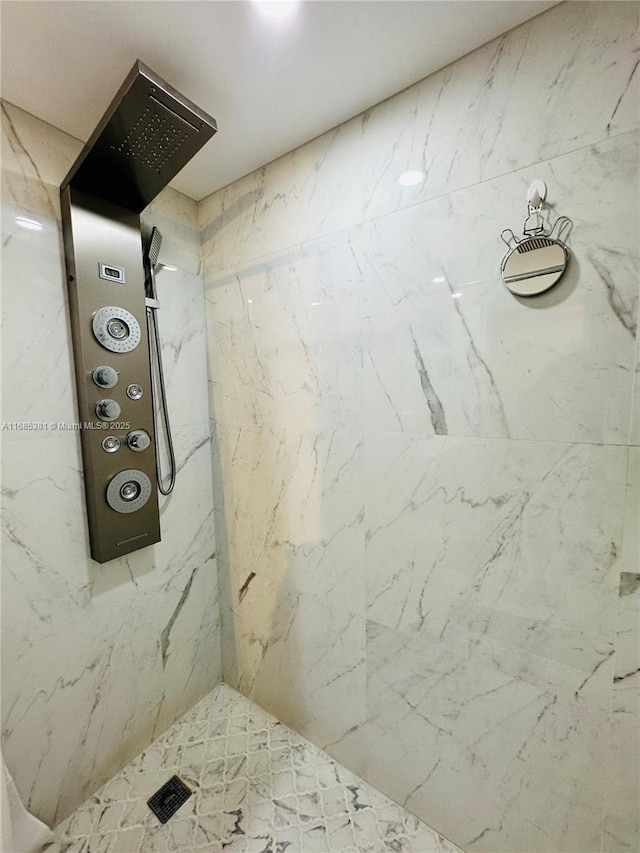 bathroom with a tile shower