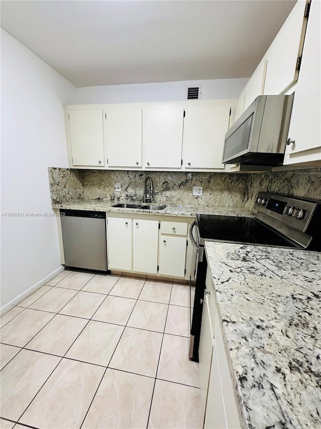 kitchen with white cabinets, appliances with stainless steel finishes, and sink