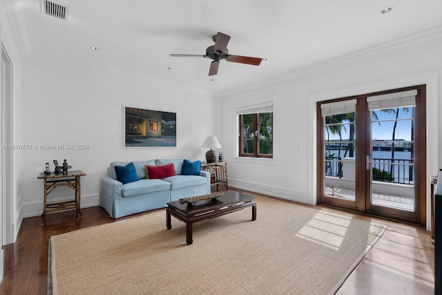 living room featuring a water view, wood-type flooring, plenty of natural light, and ceiling fan