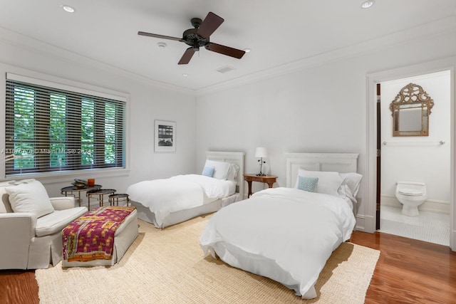 bedroom with ceiling fan, ornamental molding, ensuite bath, and hardwood / wood-style floors