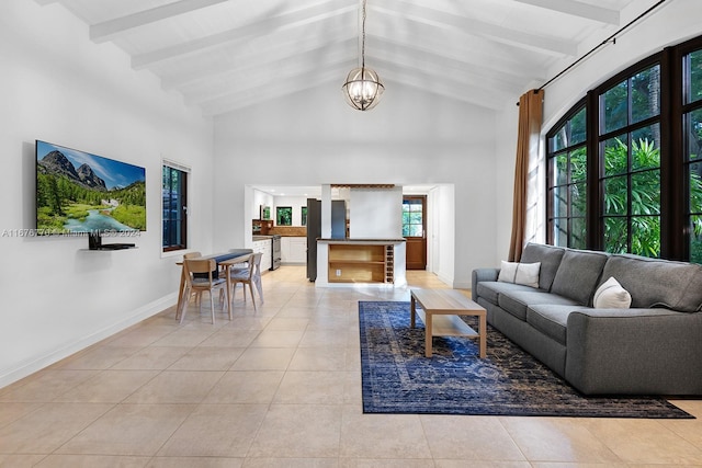 tiled living room with beam ceiling, a chandelier, and high vaulted ceiling