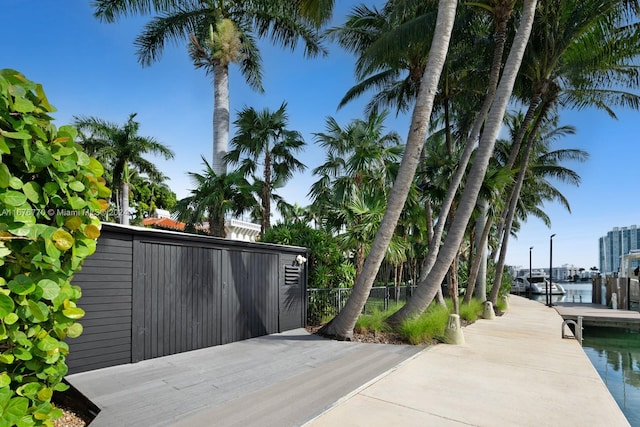 exterior space with a water view and a boat dock